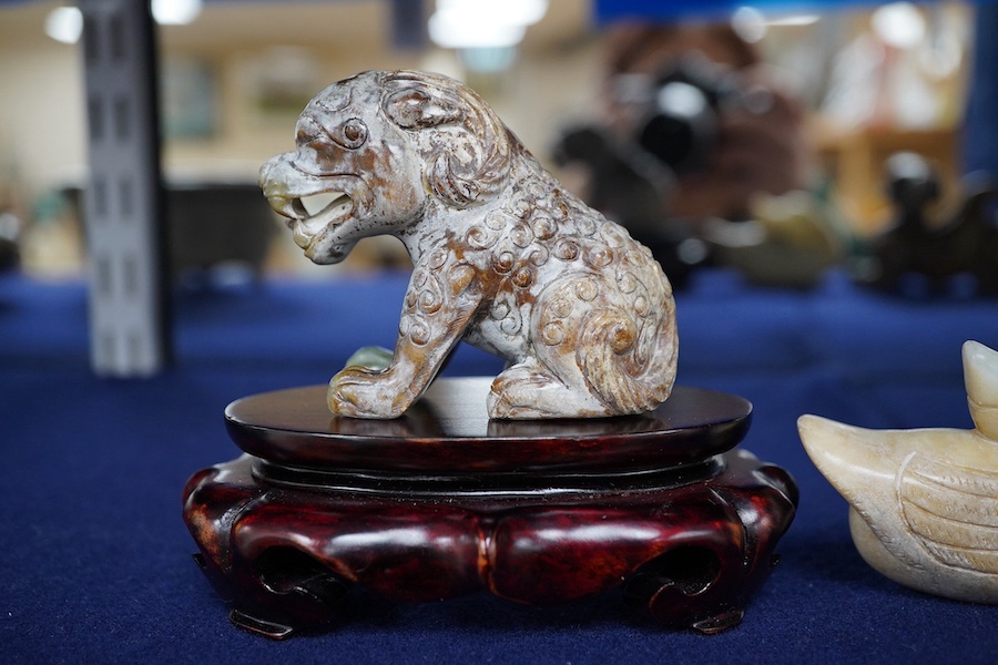 Three Chinese archaistic jade carvings of a winged mythical beast, a duck and a horned seated beast, one stand, largest 13cm wide, 7.5cm high. Condition - good.